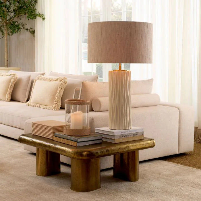 Eichholtz Coffee Table Bellington in textured vintage brass with organic curved top and sculptural cylindrical legs