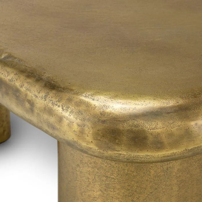 Eichholtz Coffee Table Bellington in textured vintage brass with organic curved top and sculptural cylindrical legs