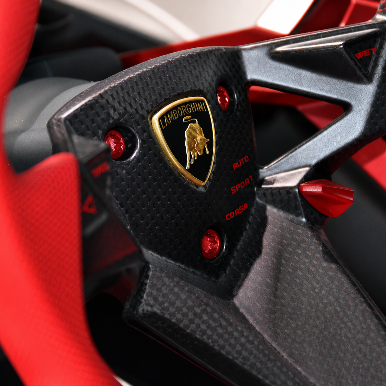 Close-up of a Lamborghini carbon fiber steering wheel showcasing lightweight composite materials used in luxury automotive engineering and high-performance supercars.