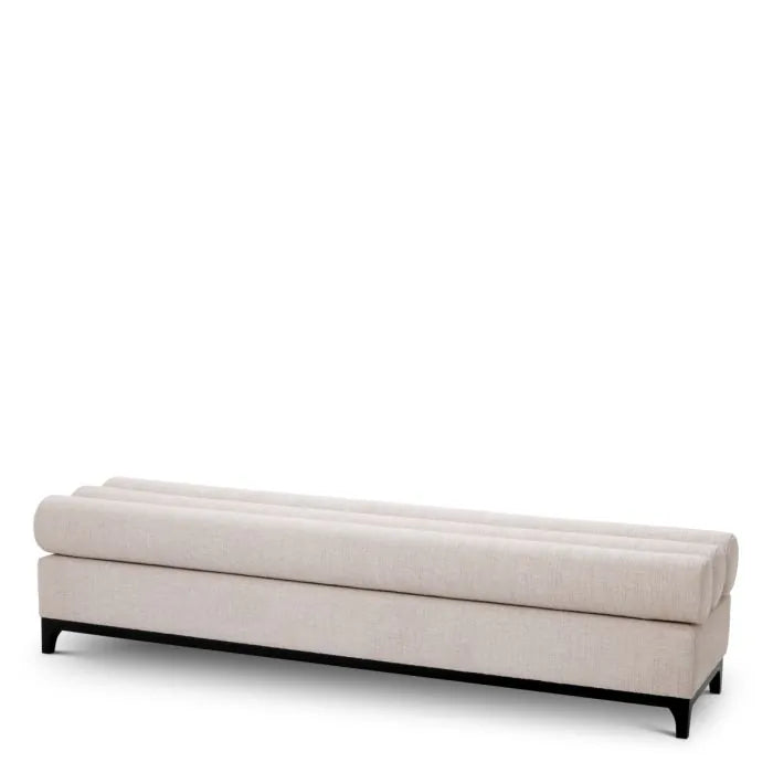 Eichholtz Bench Halbury upholstered in Alturo beige fabric with horizontal bolster cushions and sleek black metal base
