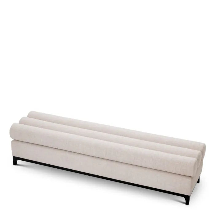Eichholtz Bench Halbury upholstered in Alturo beige fabric with horizontal bolster cushions and sleek black metal base