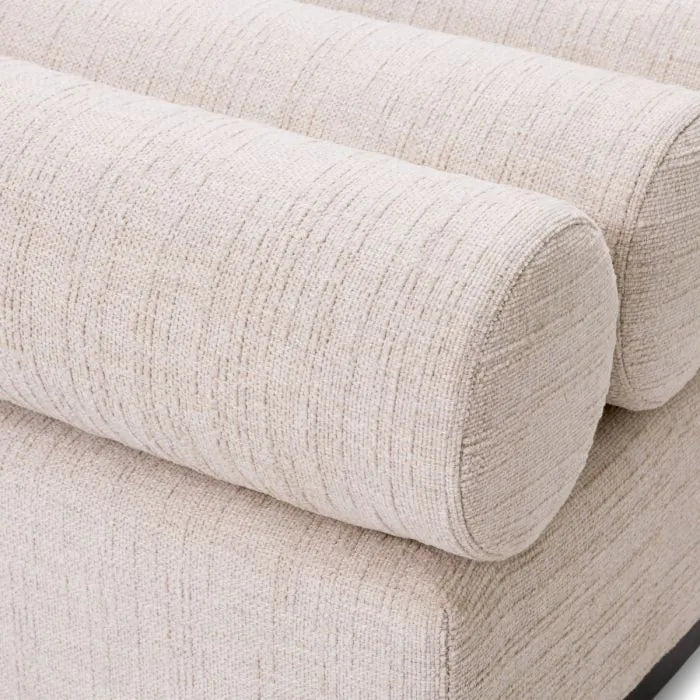 Eichholtz Bench Halbury upholstered in Alturo beige fabric with horizontal bolster cushions and sleek black metal base